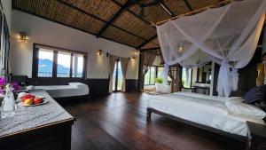 a bedroom with a bed and a table with a plate of fruit at A Su Homestay Mù Cang Chải in Mù Cang Chải