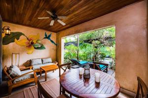a living room with a wooden table and chairs at Sunset & Oceanview Terrace, Pool, Beach And Grill in Tamarindo