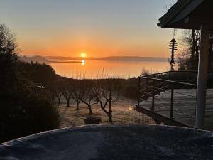 a sunset over a body of water with a dock at Holiday Home Nico - 70m to the inlet by Interhome in Roslev +22 photos