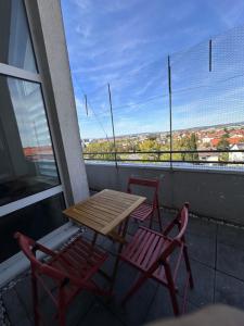 a table and two chairs on a balcony with a view at Airport Apartments Rüsselsheim in Rüsselsheim