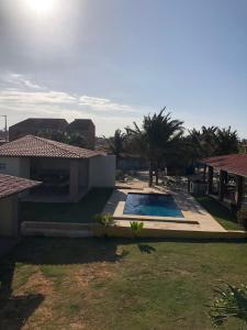 a house with a swimming pool in a yard at Casa dunas in Guajiru +13 photos