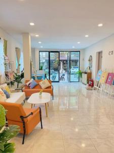 a lobby with couches and tables in a store at Chen Inn Boutique Hotel 普吉岛心澄酒店 in Patong Beach