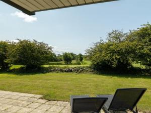 two chairs sitting on a patio in a yard at Holiday Home Erlinda - 600m from the sea by Interhome in Humble +17 photos