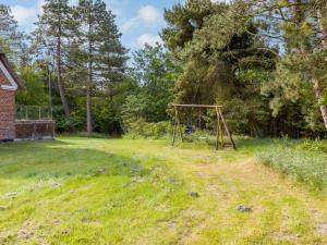 a swing set in the middle of a yard at Holiday Home Ibbe - 3-5km from the sea by Interhome in Bolilmark
