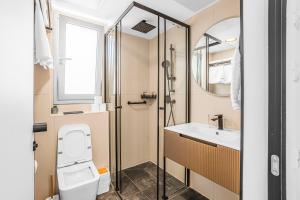 a bathroom with a toilet and a sink at Yalarent Amazing apartments U360 Complex Eilat in Eilat