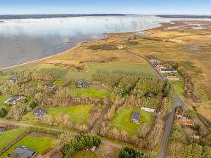 an aerial view of a golf course next to the water at Holiday Home Marika - 400m to the fjord by Interhome in Spottrup