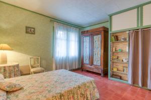 une chambre d'hôtel avec un lit et une fenêtre dans l'établissement La Coustouline, à Lacoste