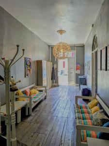a living room with two beds and a chandelier at White Chapel in Condom