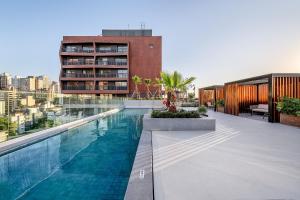 a swimming pool on the roof of a building at Cond Skyline in Porto Alegre