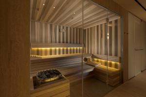 a sauna with a glass wall at Yalarent Amazing apartments U360 Complex Eilat in Eilat