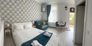 a bedroom with a bed and a living room at Centru Vechi Brasov in Braşov