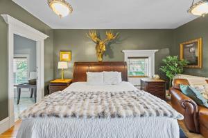 a bedroom with a bed and a deer head on the wall at Historic Cotton Mansion by Heirloom Boutique Collection in Duluth