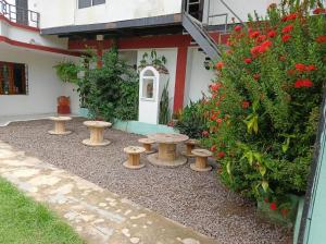 a garden with a group of stools in front of a building at Casa S&J in Mompos