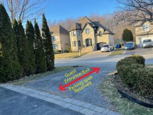 a sign on the sidewalk in front of a house at Private apartment-separate in Pincourt
