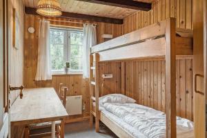 a bedroom with a bunk bed and a table and a desk at 10288-Ulfborg-Svollingvej-13 in Øhuse