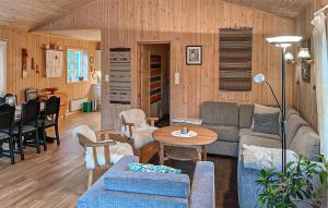 a living room with a couch and a table at 4 Bedroom Cozy Home In Straumgjerde in Brunstad