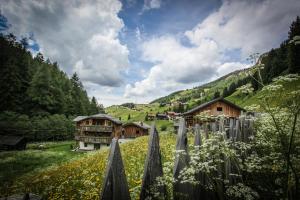 a village in the mountains with a field of flowers at Casa Serac´ in La Valle +27 photos