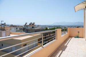 a balcony with a view of the city at Eagles Nest Panoramic SeaView Apartment in Thérissos