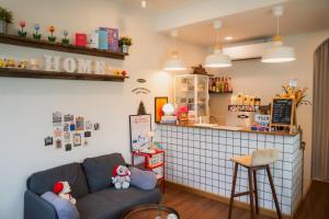 a living room with a couch and a counter at Darabbit home by darabbit home cafe in Ban Pong