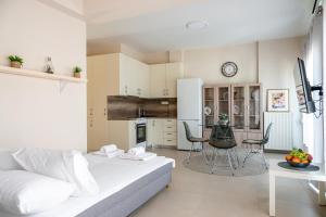 a living room and kitchen with a couch and a table at Eagles Nest Panoramic SeaView Apartment in Thérissos