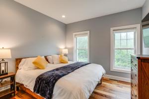a bedroom with a large bed and two windows at Game Room and Hot Tub Big Fun in Ellicottville in Ellicottville