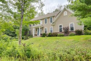 a house on a hill with trees and grass at Game Room and Hot Tub Big Fun in Ellicottville in Ellicottville