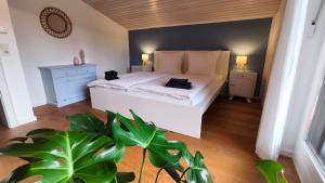 a bedroom with a bed with a cat sitting on it at Ferienhaus Fringaluna in Übersee +42 photos