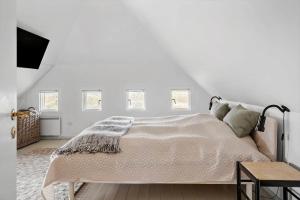a white bedroom with a bed and a tv at 20169-Ulfborg-Vederso-Klitvej-37-B in Vedersø Klit