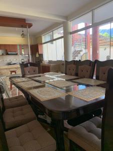 a dining room with a wooden table and chairs at Casa de Campo en el Valle Sagrado de los Incas - Casa Brisas del Rio Sagrado in Huayllabamba +28 photos