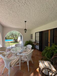 a patio with a table and chairs and a pool at Villa Solana in La Drova