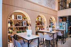 a restaurant with two tables and chairs and shelves at Kondo Hotel Allure in Budva