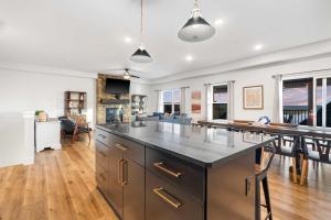 a kitchen with a large island and a living room at Pineapple Shores - Stay for 14 in Hollister +31 photos