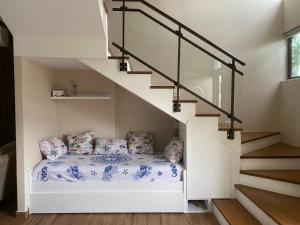 a room with a bed under the stairs at Villa with private pool in Draç +18 photos