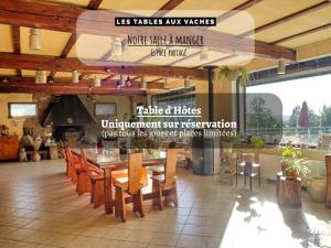 a restaurant with tables and chairs in a room at Chambres d'Hôtes avec cuisine au lac de la Raviège - Les Tables Aux Vaches in La Salvetat