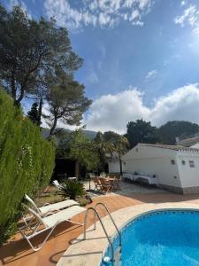 a house with a swimming pool next to a building at Villa Solana in La Drova