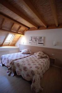 a bedroom with a bed and a window at Casa de los Beneficiados in Roncesvalles