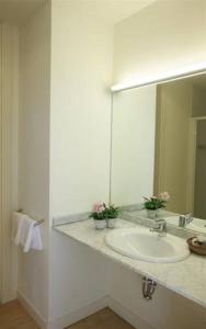 a bathroom with a sink and a large mirror at Casa de los Beneficiados in Roncesvalles
