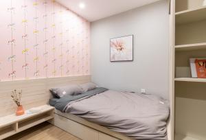 a bedroom with a bed and a wall with stars at StayLocal Apartment in Long Bình