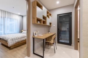 a bedroom with a desk and a bed in a room at StayLocal Apartment in Long Bình