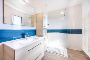 a bathroom with a sink and a mirror at La Maison du Payré - 2 personnes in Talmont +20 photos