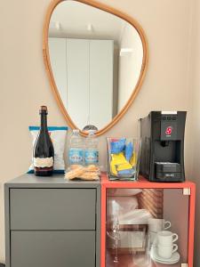 モデナにあるRed Collection, Boutiques Rooms & Suites, Modena City Centerの鏡付きテーブル、ワイン1本