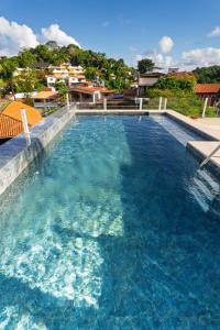 a large swimming pool with blue water at Boho Loft Escape Pool Balcony & Champagne in Cayru