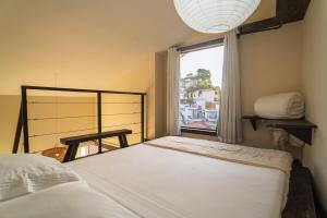 a bedroom with a large bed and a window at Morro de São Paulo - Boho Loft Escape Pool Balcony & Champagne in Cairu +36 photos