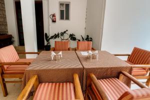 a table and chairs in a room with a table and chairs at Vista Hills by Bala's in Mussoorie