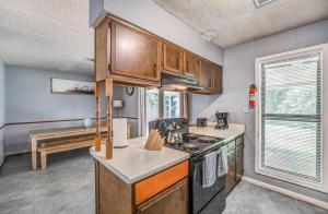 a kitchen with wooden cabinets and a stove at Wildwind Charmer in Memphis