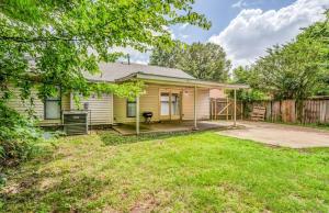 a small yellow house with a fence at Wildwind Charmer in Memphis