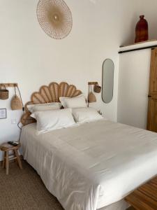 a bedroom with a large bed with white sheets at O'Manava Lodge & Bien-Etre in Virac +39 photos