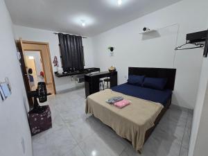 een slaapkamer met een bed en een bureau erin bij Flat completo 14 minutos do centro do Buriti Shopping in Aparecida de Goiania