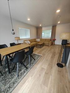 a living room with a table and chairs and a couch at Close to the Sea, Scandi Style house in Porvoo