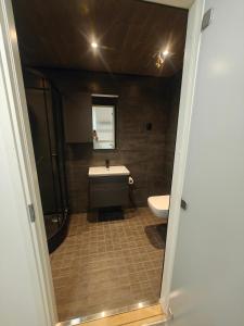 a bathroom with a toilet and a sink at Close to the Sea, Scandi Style house in Porvoo +10 photos